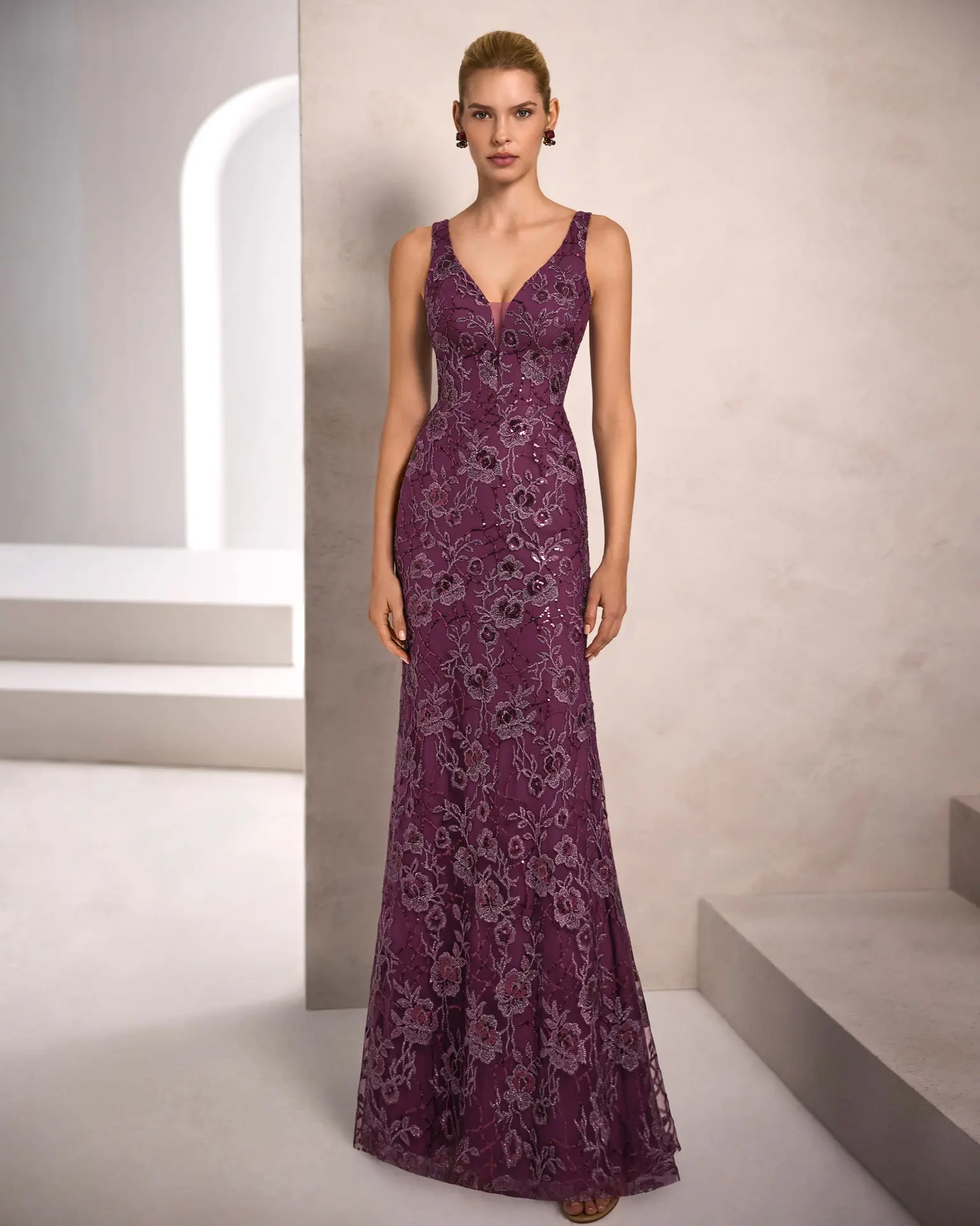 Vestito da cerimonia elegante da donna lungo viola in pizzo floreale, scollo profondo a V e spalline larghe, con sovragonna ampia in mikado viola con fiocco scenografico sul punto vita - Lo Specchio Atelier Abiti da Cerimonia a Verona