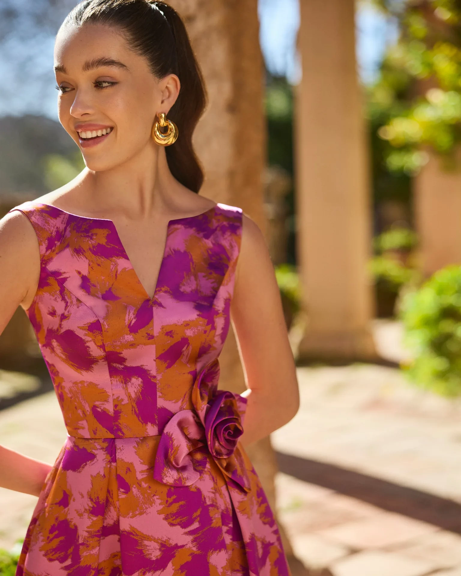 Abito lungo da cerimonia perfetto per una mamma degli sposi che ama i colori intensi, in mikado con stampa artistica sui toni del rosa e del senape, scollo a barchetta con apertura a V frontale, gonna ampia strutturata, rosa 3D applicata sul punto vita - Lo Specchio Atelier Abiti da Cerimonia a Verona